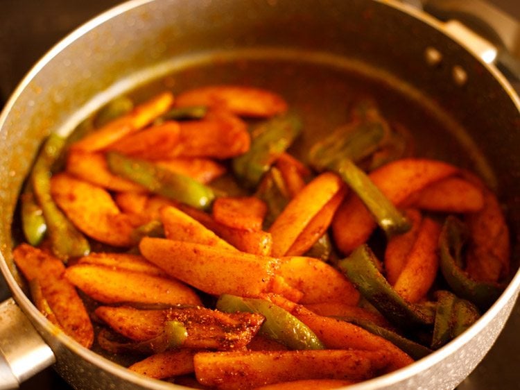 ground spices mixed evenly and aloo capsicum sabzi is ready to be served. 