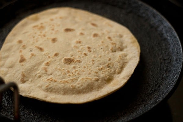 second side of cooked aloo paratha is still dry, but has a few golden spots on it like a tortilla.