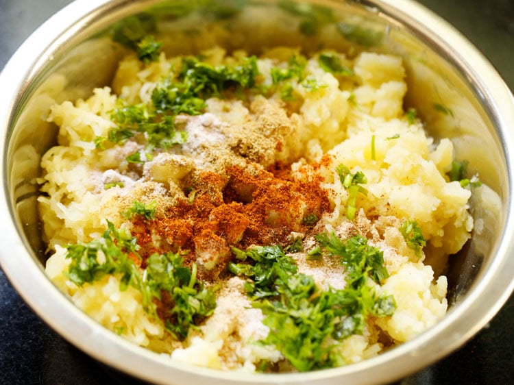 spices, herbs and salt added to mashed potatoes.