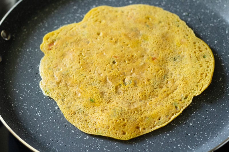 top shot of flipped side of besan chilla on skillet
