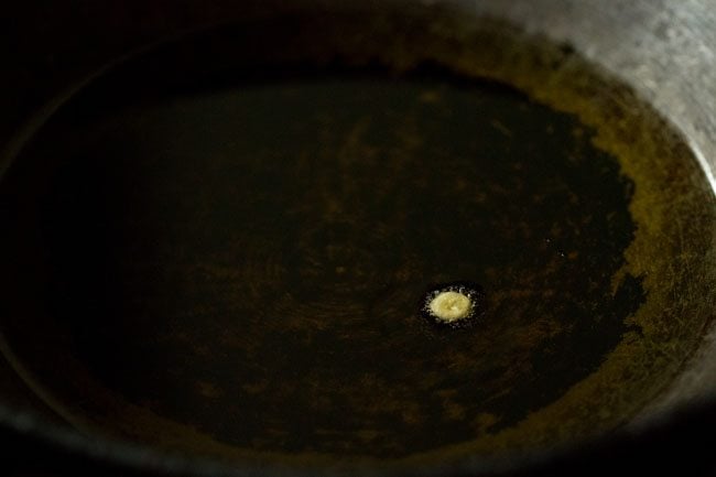 testing a small droplet of batter in hot oil