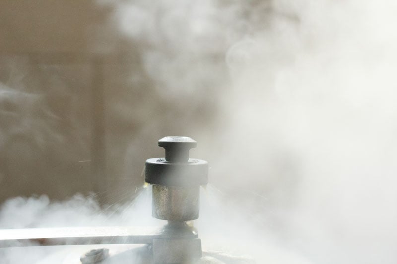 pressure cooker whistling with steam all over