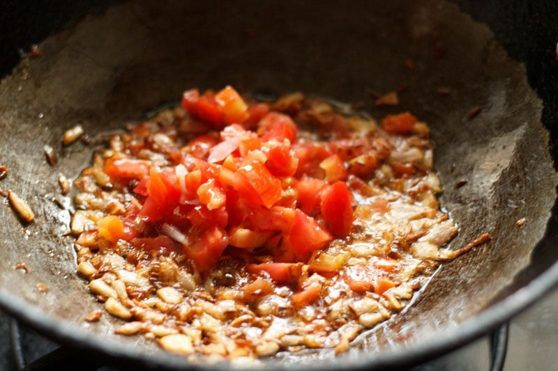 chopped tomatoes in wok