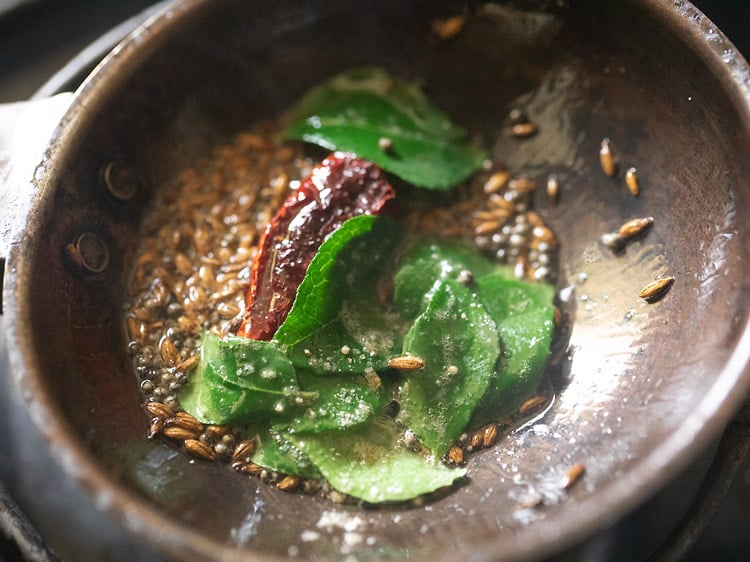 curry leaves, asafoetida  and dried red pepper added to tadka pan