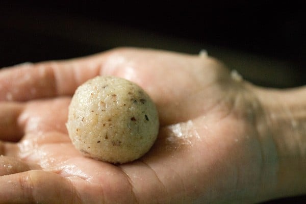 shaped coconut ladoo in a palm
