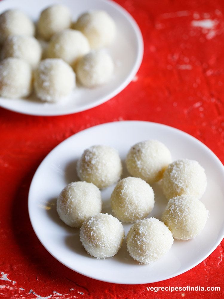 coconut ladoo on a white plate on a red table