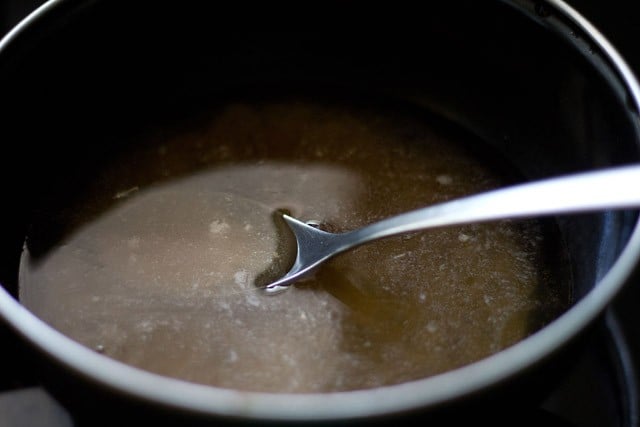 sugar solution in a pan to make nariyal ke laddu