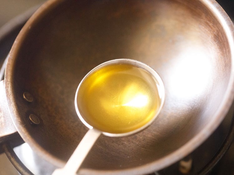 adding sesame oil in a small tadka pan.