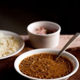 dal bukhara served in white bowl with a spoon inside the bowl