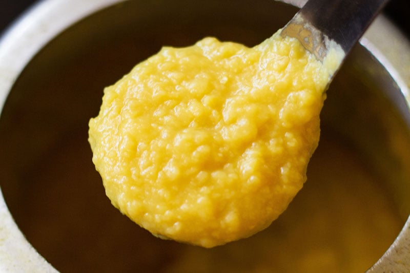 cooked yellow lentils in a spoon