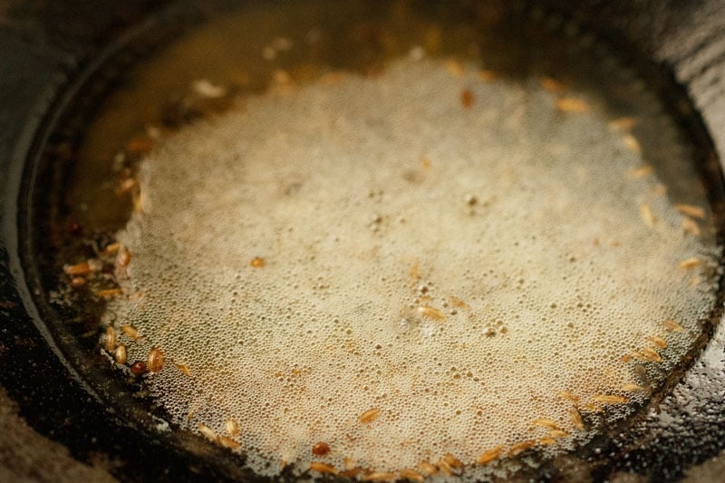 Cumin seeds and oil frying in the kadai 