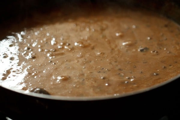mixing cream with the dal makhani