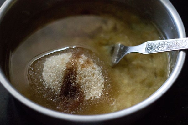 Fork whisking together oil, sugar, vanilla extract, and mashed bananas in small bowl
