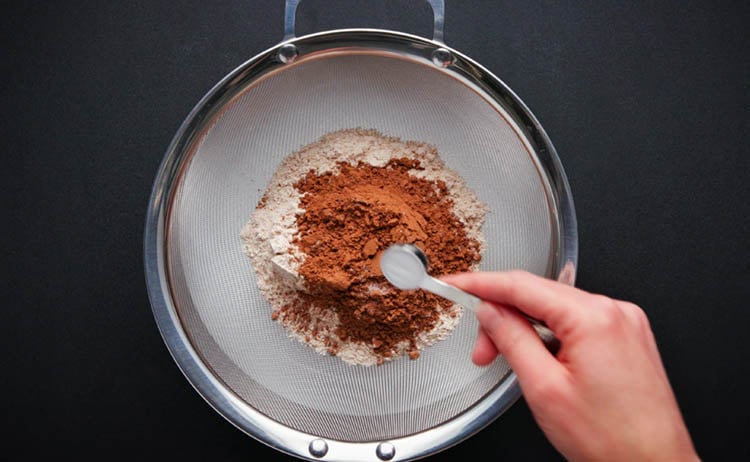 baking soda being added in the sieve