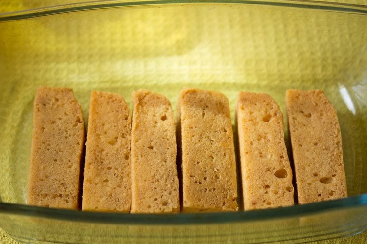 layer of soaked sponge fingers in a glass loaf pan
