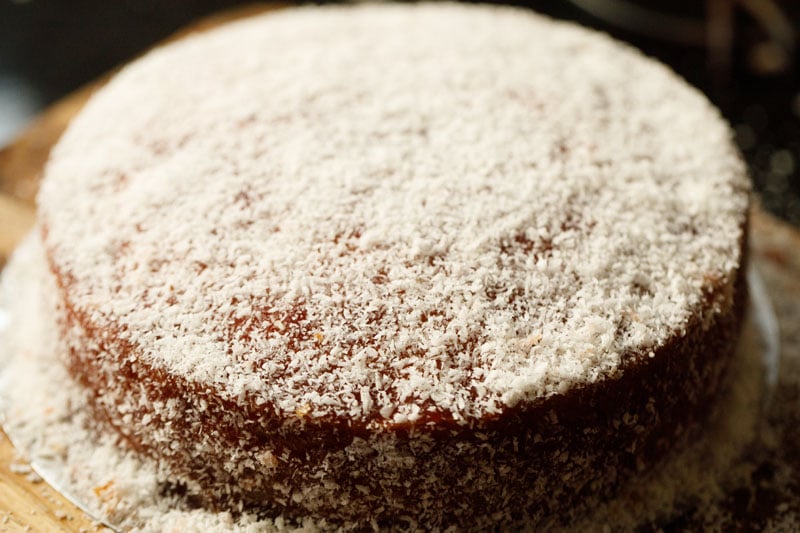 eggless vanilla cake with jam icing topped with desiccated coconut