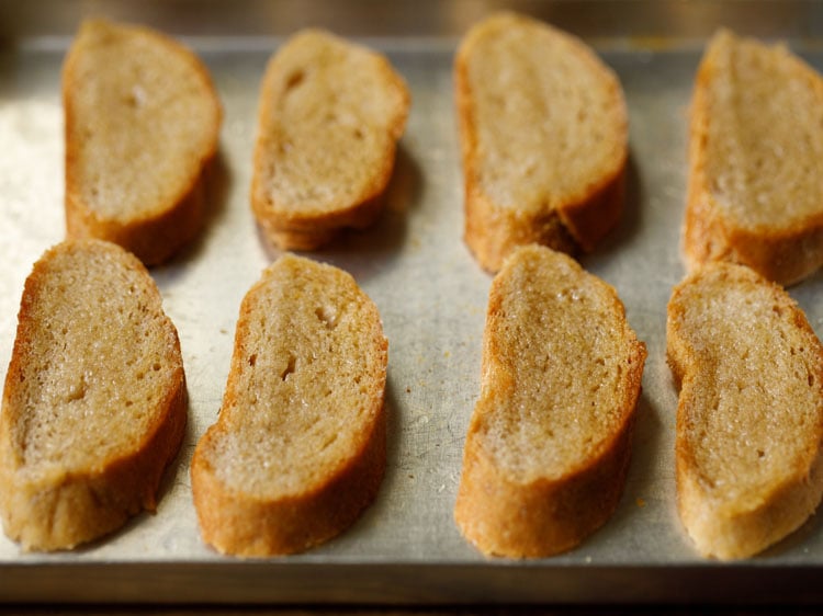 baguette slices brushed with olive oil and placed on baking tray