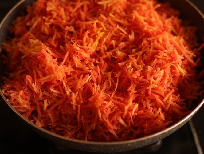 grated carrots in pan