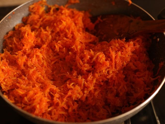grated carrots being sautéed in ghee