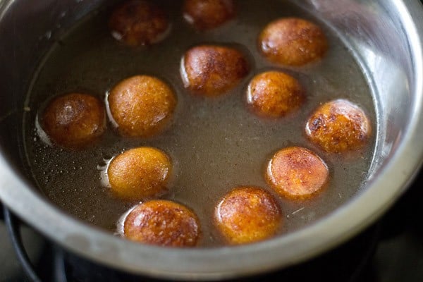 fried gulab jamun balls added into sugar syrup
