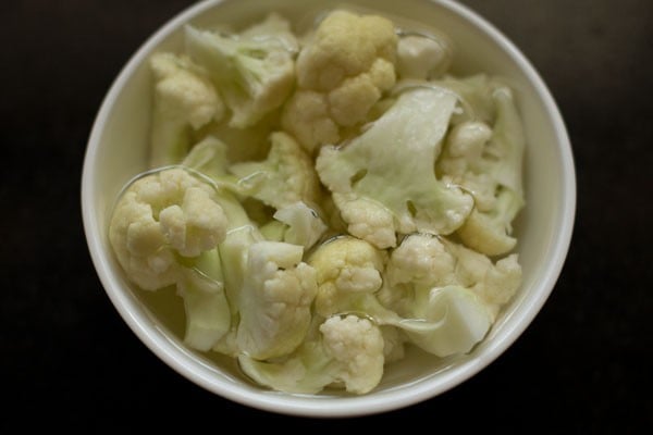 cauliflower being blanched in water for kurma recipe