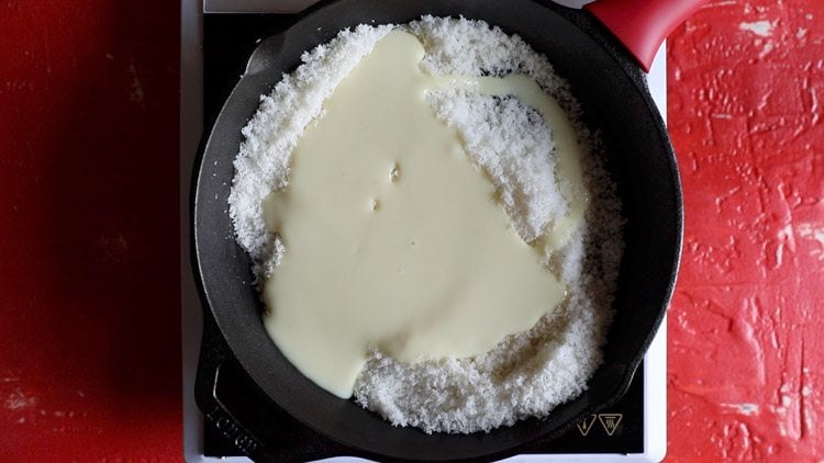 condensed milk on top of desiccated coconut in skillet
