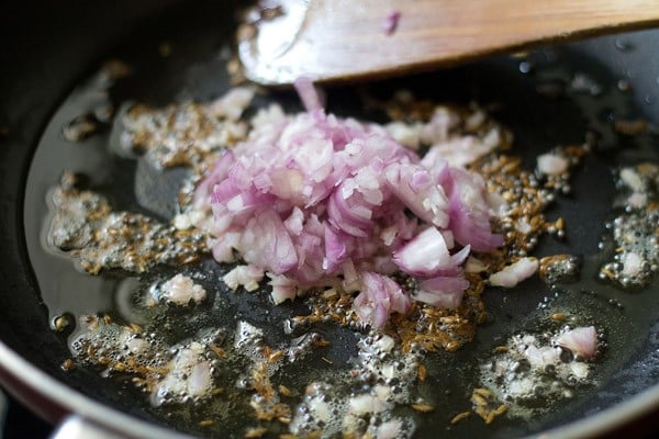 onions added to the pan for kanda batata poha. 