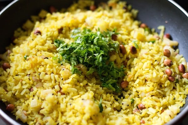coriander leaves added to the cooked poha. 