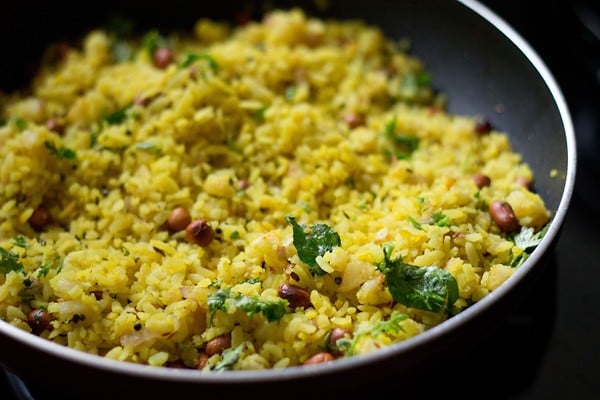 coriander leaves mixed with the cooked poha. 