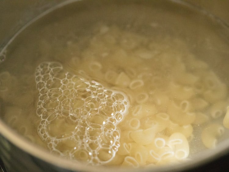 macaroni and salted water in a saucepan