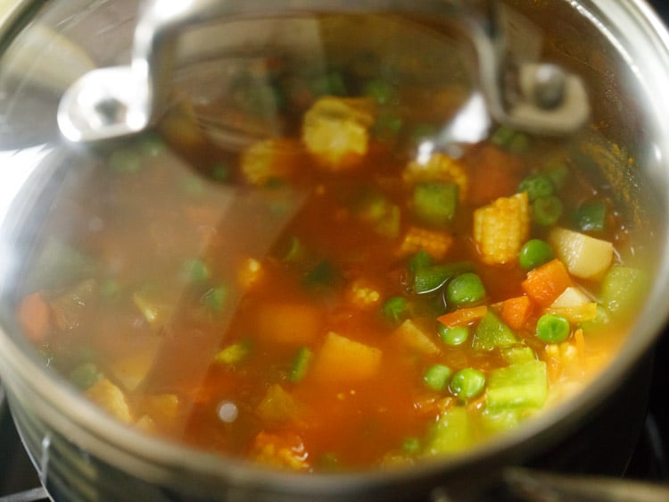 vegetables and water in a saucepan covered with a lid