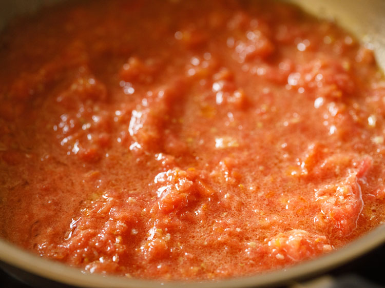 mixed and cooking tomato puree further