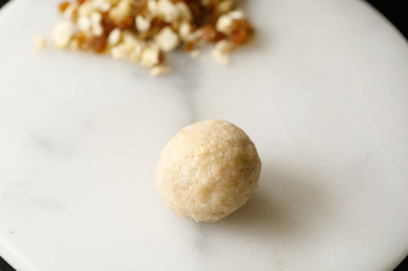 sealed and shaped kofta ball with the cashew, raisins mixture inside
