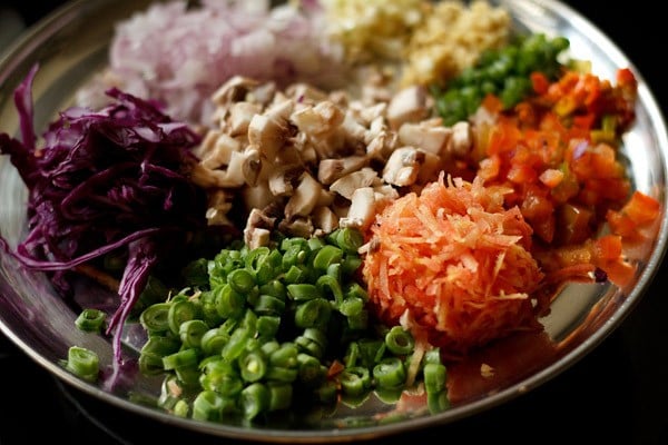 chopped and grated vegetables on a plate ready to make manchow soup
