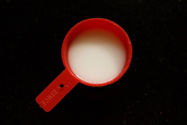 corn starch slurry in a red measuring cup 