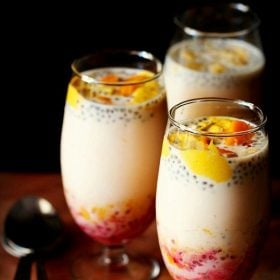 mango falooda served in three glasses with spoons kept on the side.