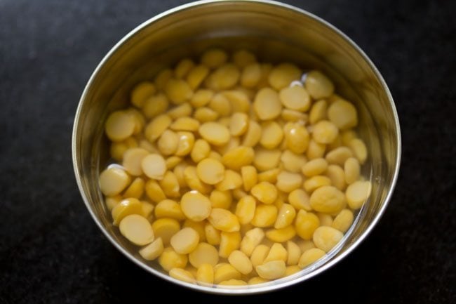 chana dal soaked in water in a bowl