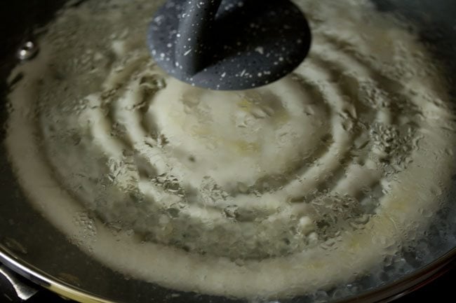 cooking dosa after covering it with a lid