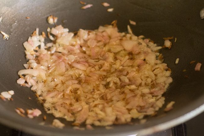 onions being sautéed in pan