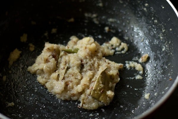 sautéing ground onion-ginger-garlic paste in the pan