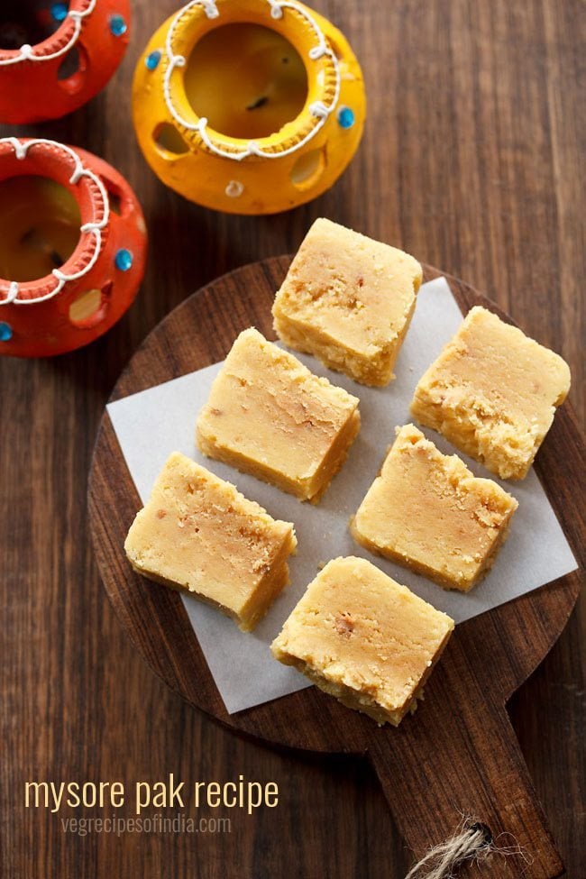 cubes of mysore pak on a wooden serving tray on a table