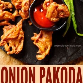onion pakoda with salted green chillies on a black granite with text layovers