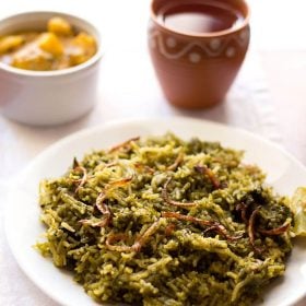 palak biryani served on a white plate.