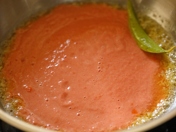 tomato purée added to pan to make paneer butter masala gravy