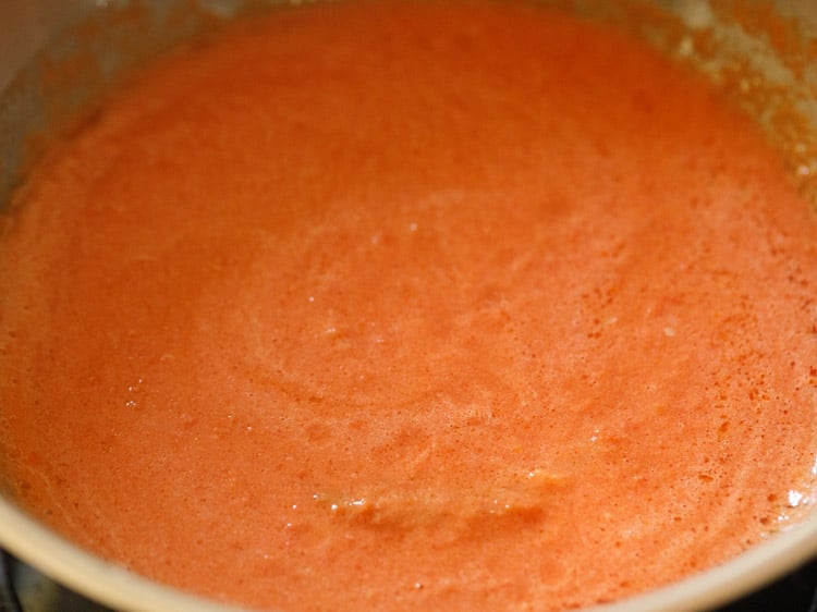 tomato puree being cooked for making paneer butter masala gravy from scratch