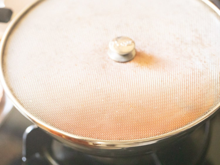 splatter lid kept on the pan