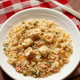 paneer fried rice served on a white plate.