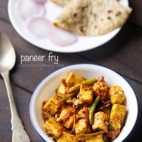 paneer fry served in a white bowl with a spoon kept on the left side, chapattis and onion rings kept on a white plate on the top side and text layovers.