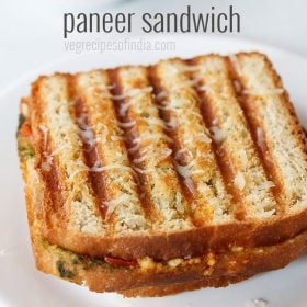 paneer sandwich with cheese served on a white plate with text layovers.