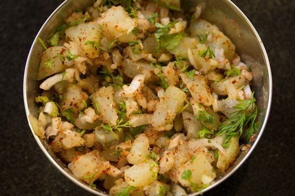 mixing potatoes with herbs and spices